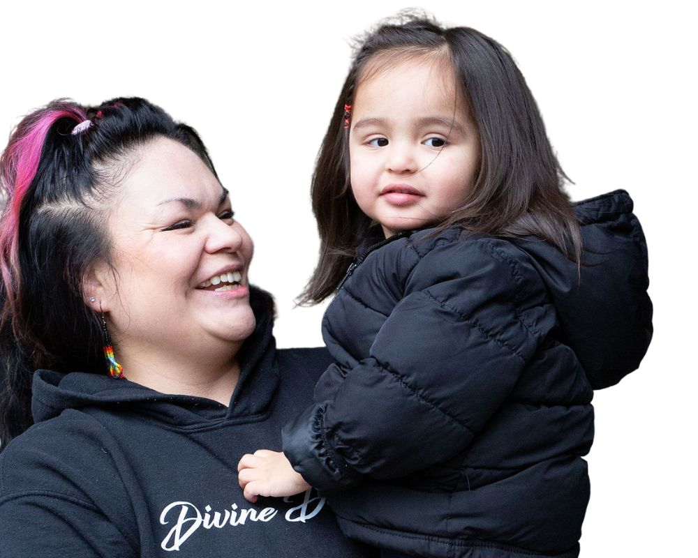 Image of YWCA program participants. Mom holding up daughter and smiling.
